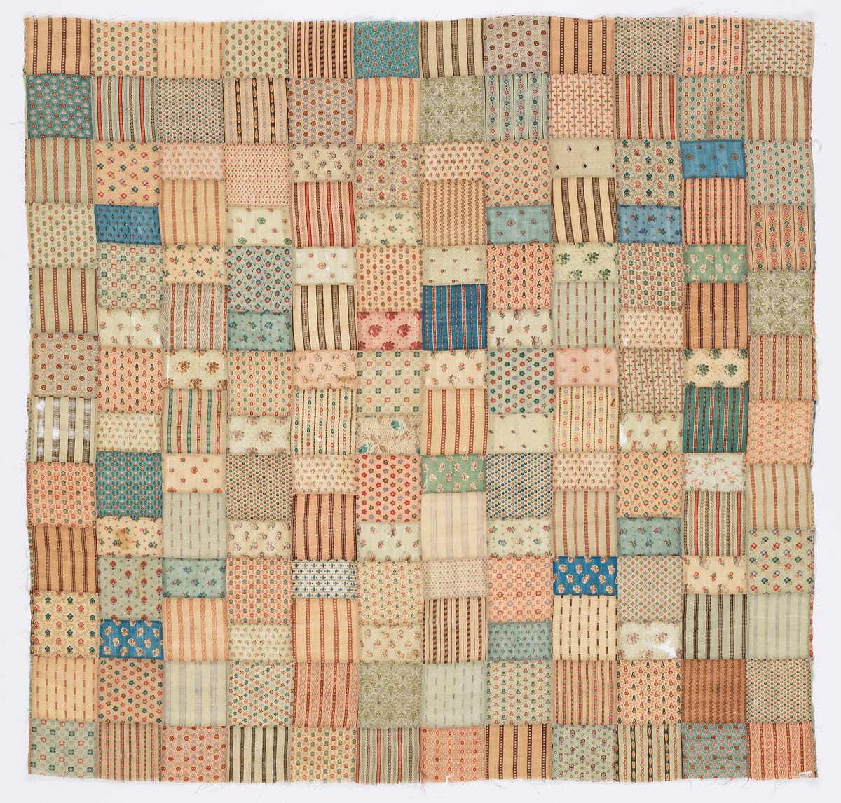 Patchwork quilt top of about 144 printed wool squares, for the quilt fabric calculator